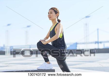 Young Japanese Woman Stretching Downtown Tokyo, Japan View Large Photo Image Stock Image - Young Japanese Woman Stretching Downtown Tokyo, Japan. Fotosearch