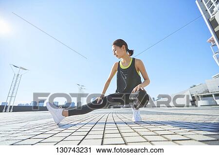 Young Japanese Woman Stretching Downtown Tokyo, Japan View Large Photo Image Stock Image - Young Japanese Woman Stretching Downtown Tokyo, Japan. Fotosearch