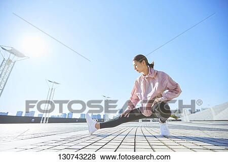 Young Japanese Woman Stretching Downtown Tokyo, Japan View Large Photo Image Stock Photo - Young Japanese Woman Stretching Downtown Tokyo, Japan. Fotosearch