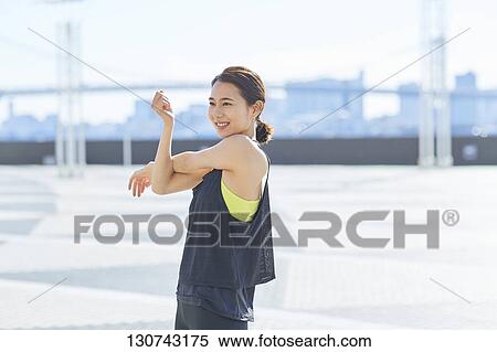 Young Japanese Woman Stretching Downtown Tokyo, Japan View Large Photo Image Stock Photography - Young Japanese Woman Stretching Downtown Tokyo, Japan. Fotosearch