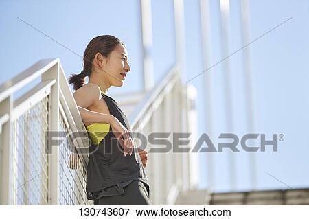 Young Japanese Woman Taking A Break During Jogging View Large Photo Image Stock Photo - Young Japanese Woman Taking A Break During Jogging. Fotosearch