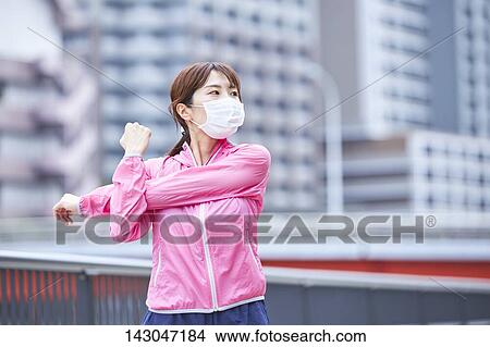 Picture - Young Japanese woman training downtown Tokyo. Fotosearch