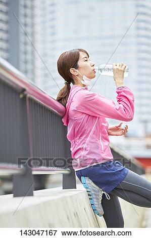 Stock Photo - Young Japanese woman training downtown Tokyo. Fotosearch