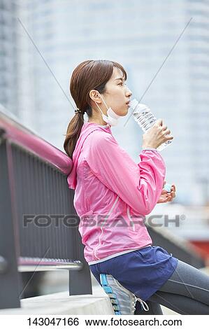 Stock Photograph - Young Japanese woman training downtown Tokyo. Fotosearch