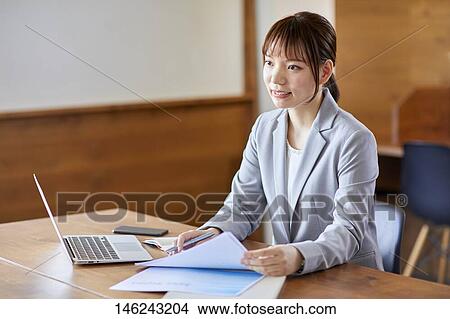 Young Japanese woman working View Large Photo Image Picture - Young Japanese woman working. Fotosearch