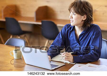 Young Japanese woman working View Large Photo Image Stock Image - Young Japanese woman working. Fotosearch