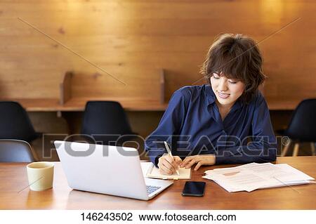 Young Japanese woman working View Large Photo Image Stock Image - Young Japanese woman working. Fotosearch