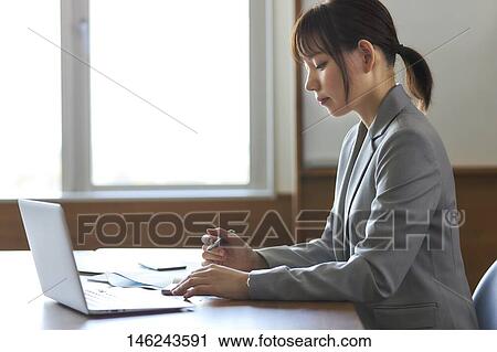 Young Japanese woman working View Large Photo Image Stock Image - Young Japanese woman working. Fotosearch