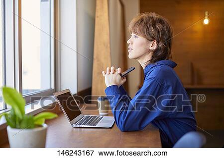 Stock Photo - Young Japanese woman working. Fotosearch