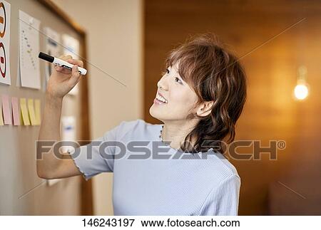 Young Japanese woman working View Large Photo Image Stock Photo - Young Japanese woman working. Fotosearch