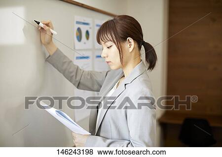 Stock Photo - Young Japanese woman working. Fotosearch