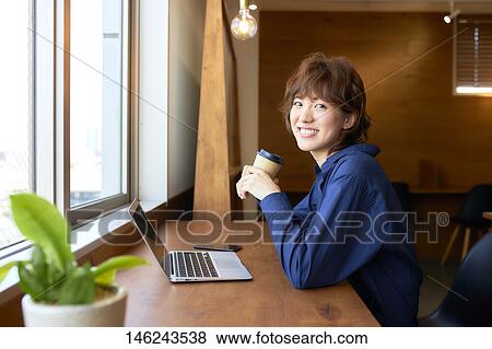 Stock Photo - Young Japanese woman working. Fotosearch
