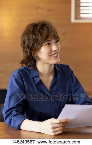 Young Japanese woman working View Large Photo Image Stock Photo - Young Japanese woman working. Fotosearch