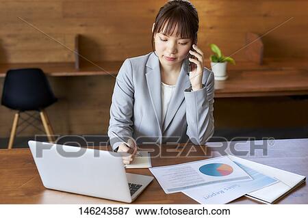 Young Japanese woman working View Large Photo Image Stock Photo - Young Japanese woman working. Fotosearch