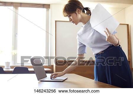 Young Japanese woman working View Large Photo Image Stock Photograph - Young Japanese woman working. Fotosearch