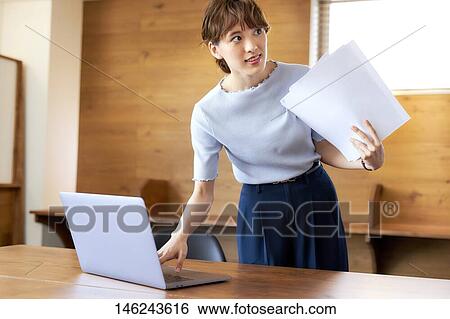 Stock Photograph - Young Japanese woman working. Fotosearch