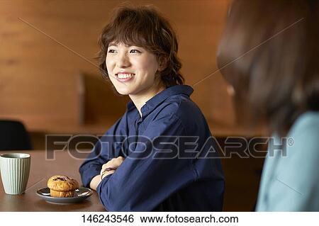 Stock Photograph - Young Japanese women at a cafe. Fotosearch
