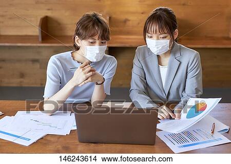 Picture - Young Japanese women working. Fotosearch