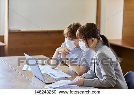 Stock Image - Young Japanese women working. Fotosearch