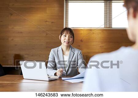 Stock Image - Young Japanese women working. Fotosearch
