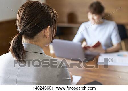 Stock Image - Young Japanese women working. Fotosearch