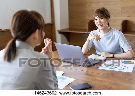 Stock Image - Young Japanese women working. Fotosearch