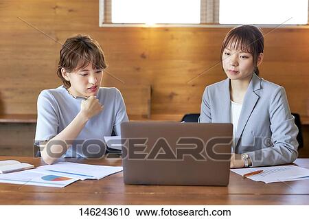 Stock Image - Young Japanese women working. Fotosearch