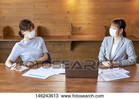 Stock Image - Young Japanese women working. Fotosearch