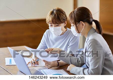 Young Japanese women working View Large Photo Image Stock Photo - Young Japanese women working. Fotosearch