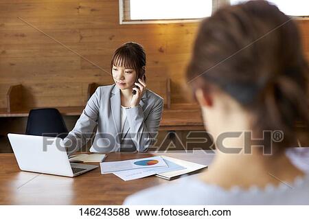 Stock Photo - Young Japanese women working. Fotosearch