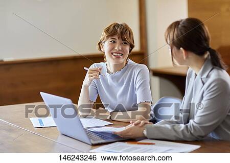 Stock Photograph - Young Japanese women working. Fotosearch