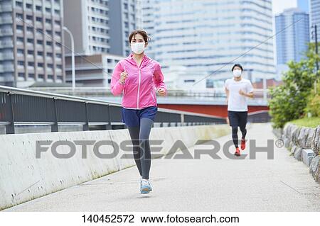 Young Man And Woman Running With Face Mask View Large Photo Image Stock Image - Young Man And Woman Running With Face Mask. Fotosearch