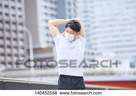 Young Man Stretching With A Face Mask View Large Photo Image Stock Photo - Young Man Stretching With A Face Mask. Fotosearch