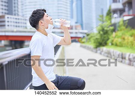Young Man Taking A Break With A Face Mask View Large Photo Image Stock Image - Young Man Taking A Break With A Face Mask. Fotosearch