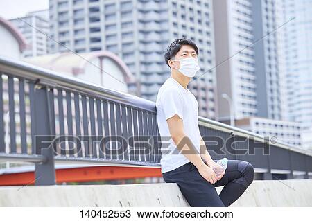 Young Man Taking A Break With A Face Mask View Large Photo Image Stock Image - Young Man Taking A Break With A Face Mask. Fotosearch