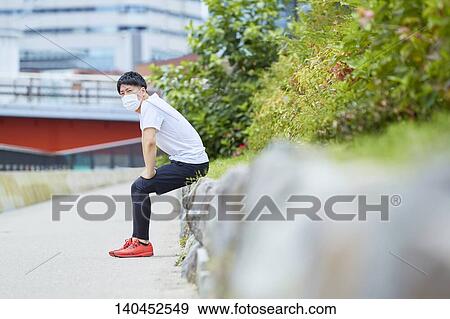 Young Man Taking A Break With A Face Mask View Large Photo Image Stock Photo - Young Man Taking A Break With A Face Mask. Fotosearch