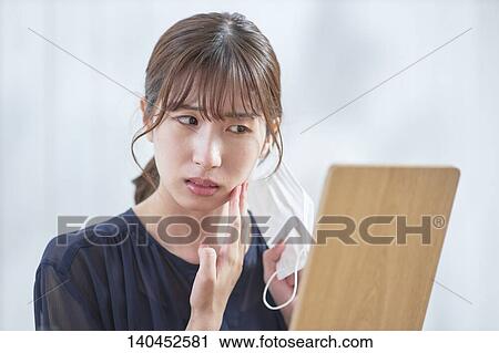 Young Woman Checking Her Face With A Mirror View Large Photo Image Stock Image - Young Woman Checking Her Face With A Mirror. Fotosearch
