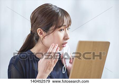 Young Woman Checking Her Face With A Mirror View Large Photo Image Stock Photo - Young Woman Checking Her Face With A Mirror. Fotosearch