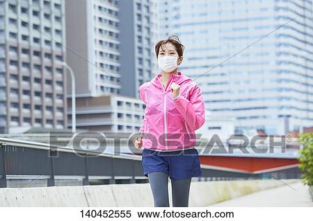 Young Woman Running With Face Mask View Large Photo Image Stock Photography - Young Woman Running With Face Mask. Fotosearch