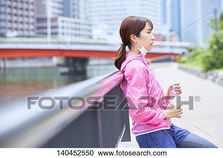 Young Woman Taking A Break With A Face Mask View Large Photo Image Stock Image - Young Woman Taking A Break With A Face Mask. Fotosearch