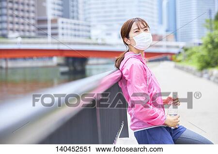 Young Woman Taking A Break With A Face Mask View Large Photo Image Stock Image - Young Woman Taking A Break With A Face Mask. Fotosearch