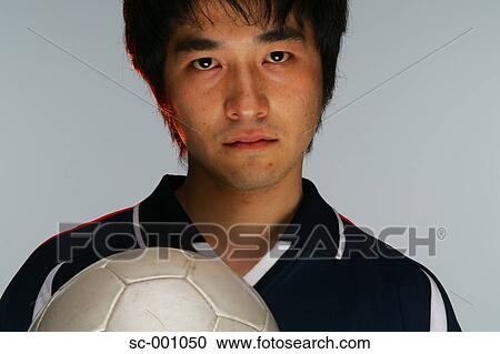 Determined soccer player holding ball View Large Photo Image Stock Image - Determined soccer player holding ball. Fotosearch