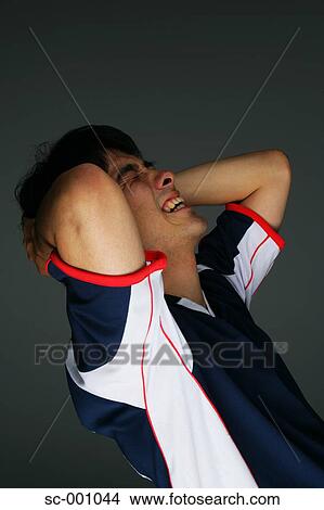 Picture - Frustrated soccer player holding hands to head. Fotosearch
