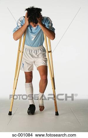 Injured soccer player using crutches View Large Photo Image Picture - Injured soccer player using crutches. Fotosearch