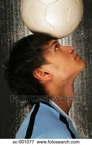 Soccer player balancing ball on head View Large Photo Image Stock Photo - Soccer player balancing ball on head. Fotosearch