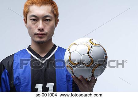 Soccer player holding ball View Large Photo Image Picture - Soccer player holding ball. Fotosearch