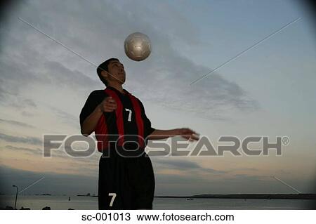 Stock Image - Soccer player juggling ball. Fotosearch