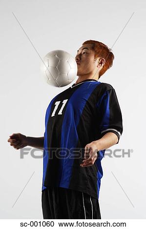 Soccer player juggling ball View Large Photo Image Stock Image - Soccer player juggling ball. Fotosearch