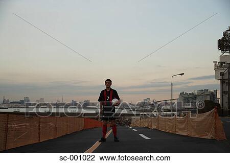 Soccer player on road View Large Photo Image Stock Image - Soccer player on road. Fotosearch