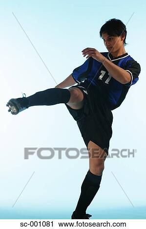 Stock Image - Soccer player performing martial arts. Fotosearch
